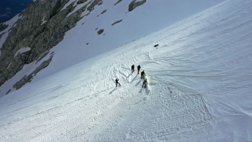 An aerial photo taken on June 19, 2020, shows workers covering the Presena glacier with huge geotextile sheets in northern Italy. 