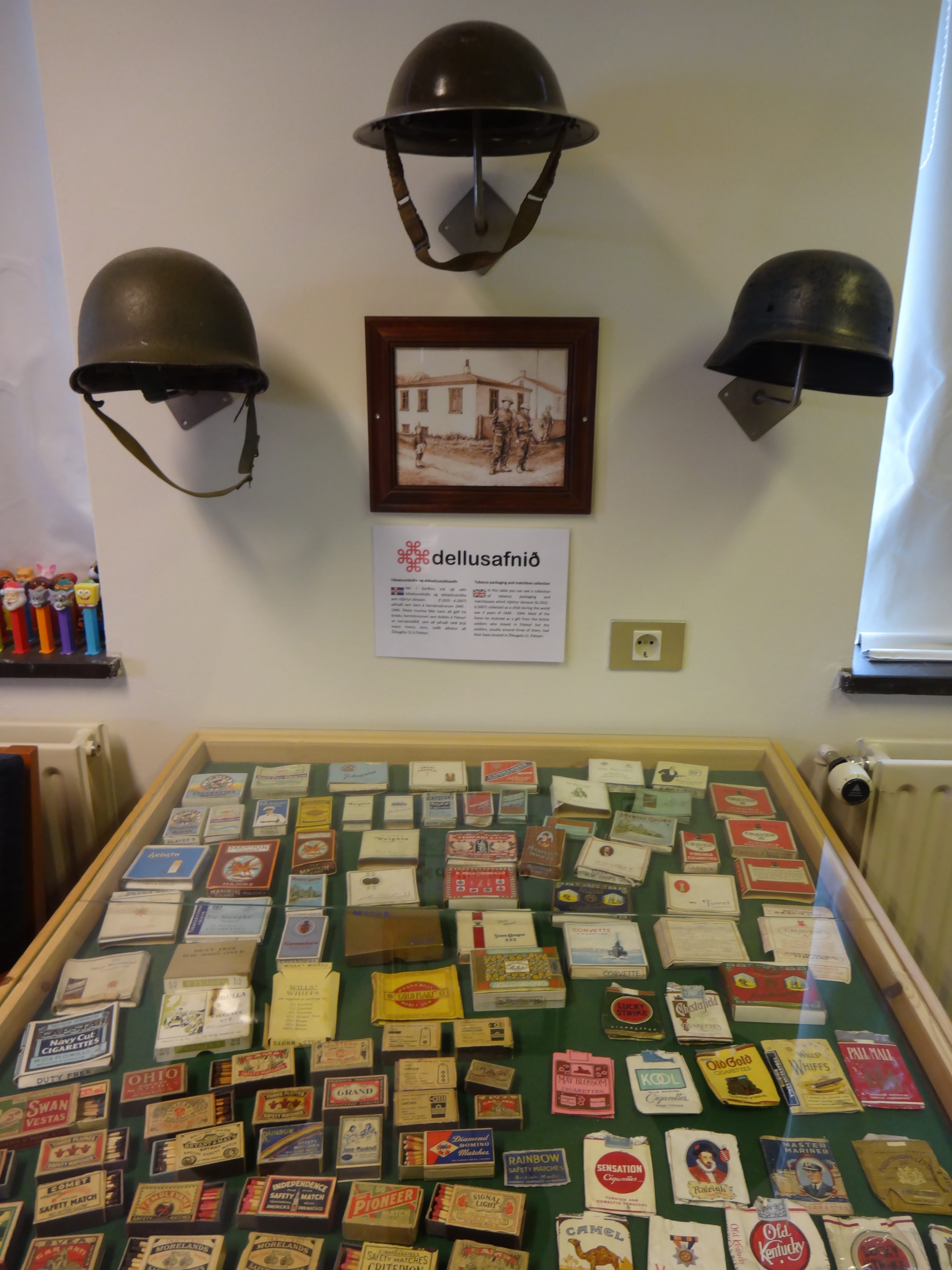 Tobacco packaging, matchbooks, Pez dispensers, and helmets at the Nonsense Museum in Flateyri. 