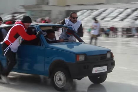 The Russian curlers sending a car down the ice.