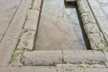Lines from Burns poetry line the edge of the pool