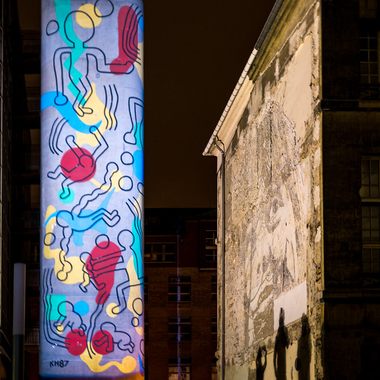 The Keith Haring Tower, lit during the night.