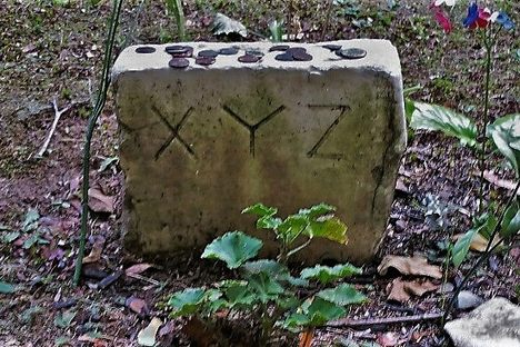 The small stone often has coins and other offerings left by visitors.