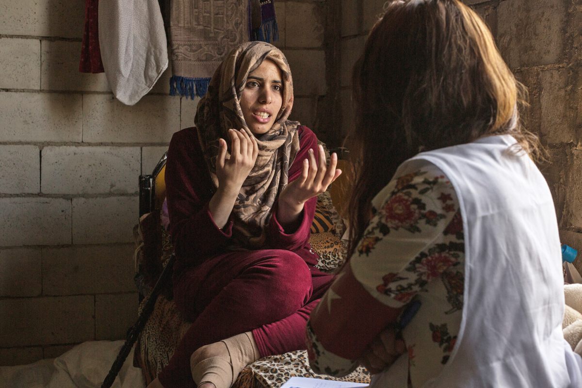 Ghadire Abdelrahman, 26, talks with Order of Malta social worker Nelly Karimeh in Khirbet Daoud. Ghadire was injured when a bomb hit her house in Syria, and she sought medical help across the border.