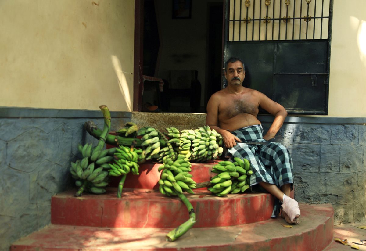 Vinod poses with a bunch of banana varieties.