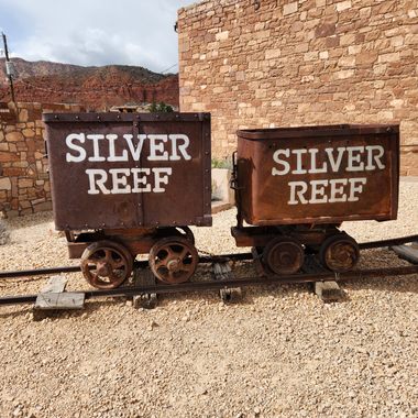 Ore cars.  Each held about a ton of rock, and a worker ("mucker") was expected to fill about 16 in a shift.