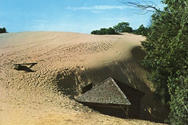 1960s-era photos show the structure being swallowed by dunes.