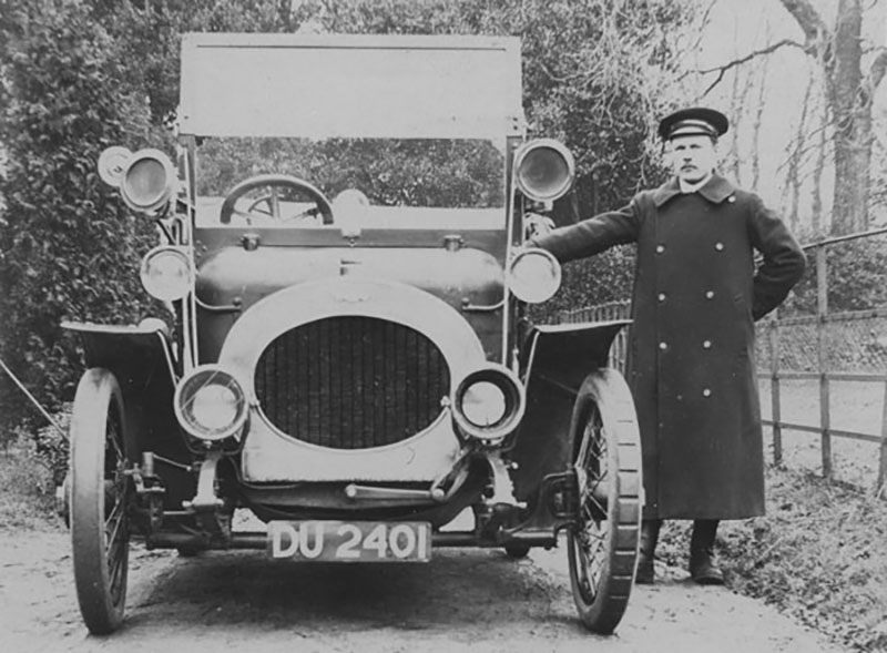 A chauffeur with a Riley car, 1910. 