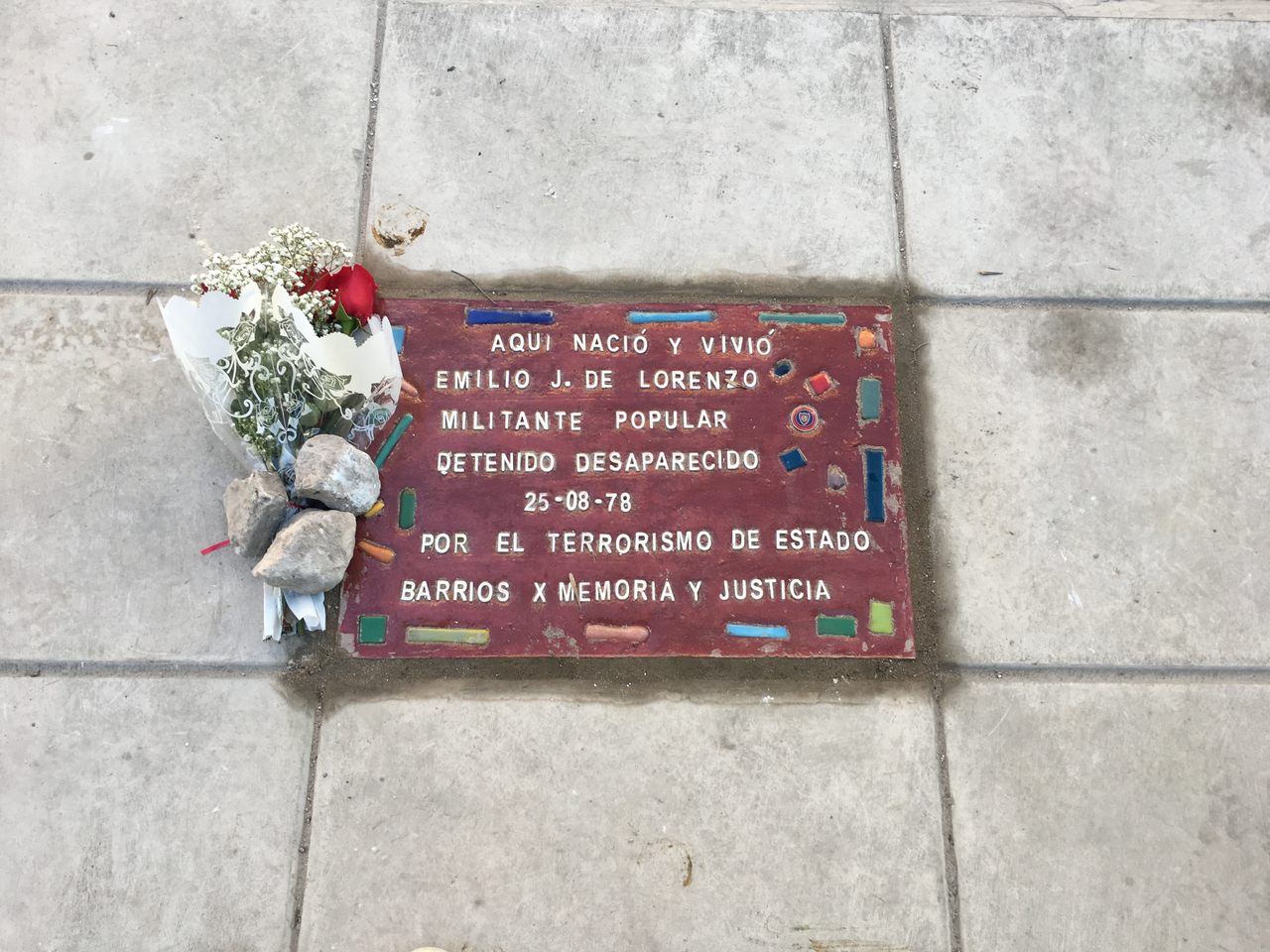 The memorial tile for Emilio de Lorenzo. 