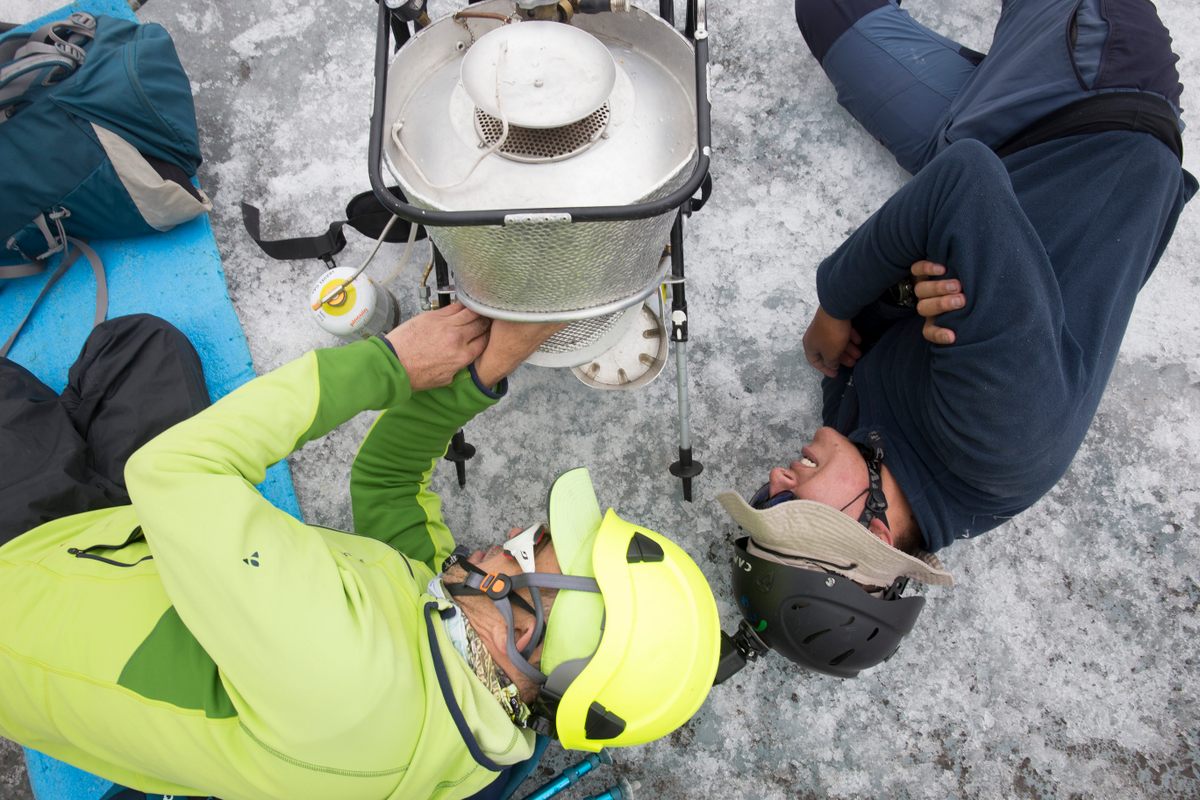 Ceballos and Mendoza work with the device they use to melt holes to track the glacier's disappearance.