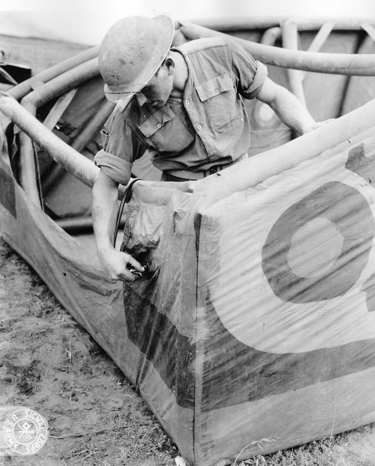 Here, a soldier is inflating the body of the tank.