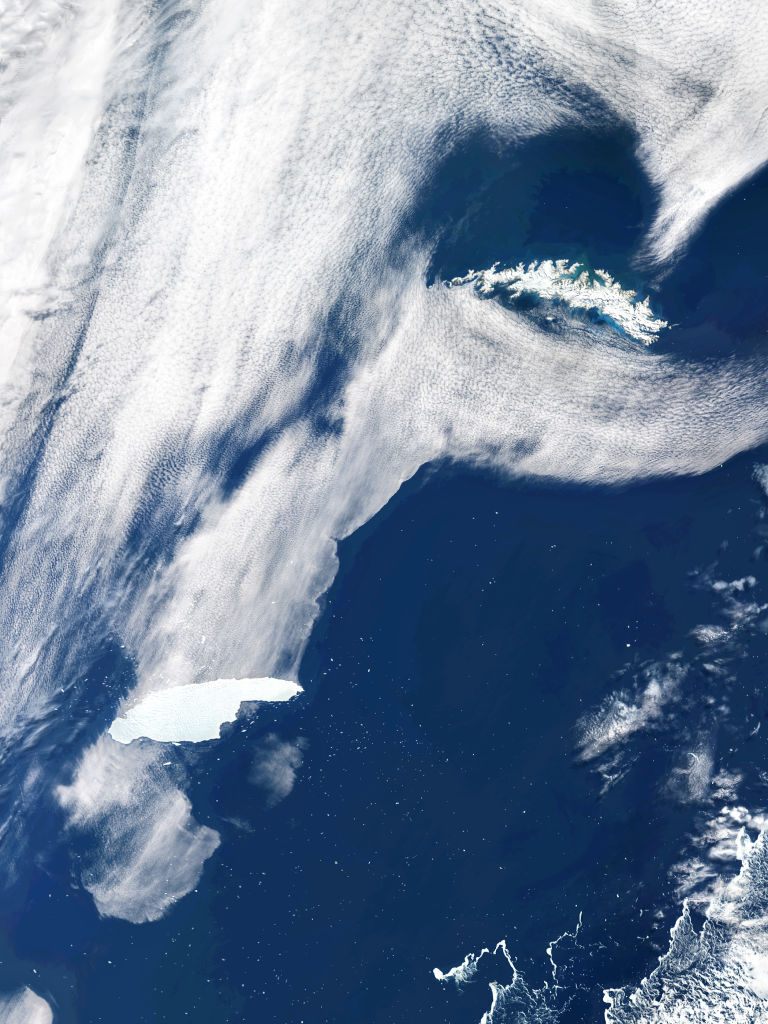 The iceberg called A-68A by the U.S. National Ice Center (bottom left) approaches South Georgia Island (top right). 