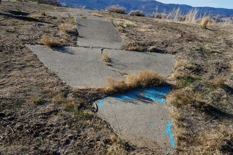 Tip of the arrow, looking back west.  The skylined mountains are Boca Ridge in California.  The blue paint is _not_ original.