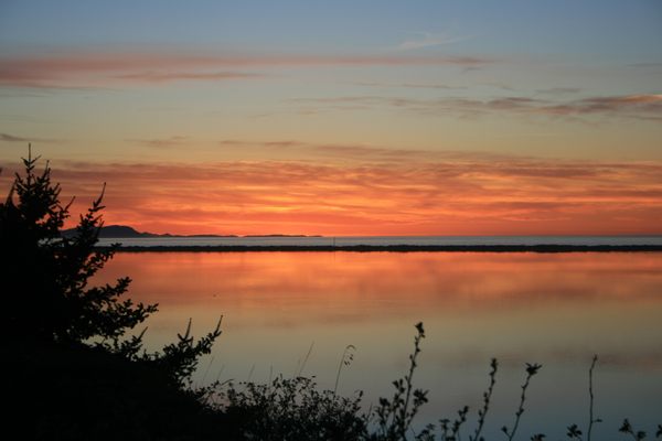 Sunset over Dungeness Spit. The calm water in the foreground is Dungeness Bay.