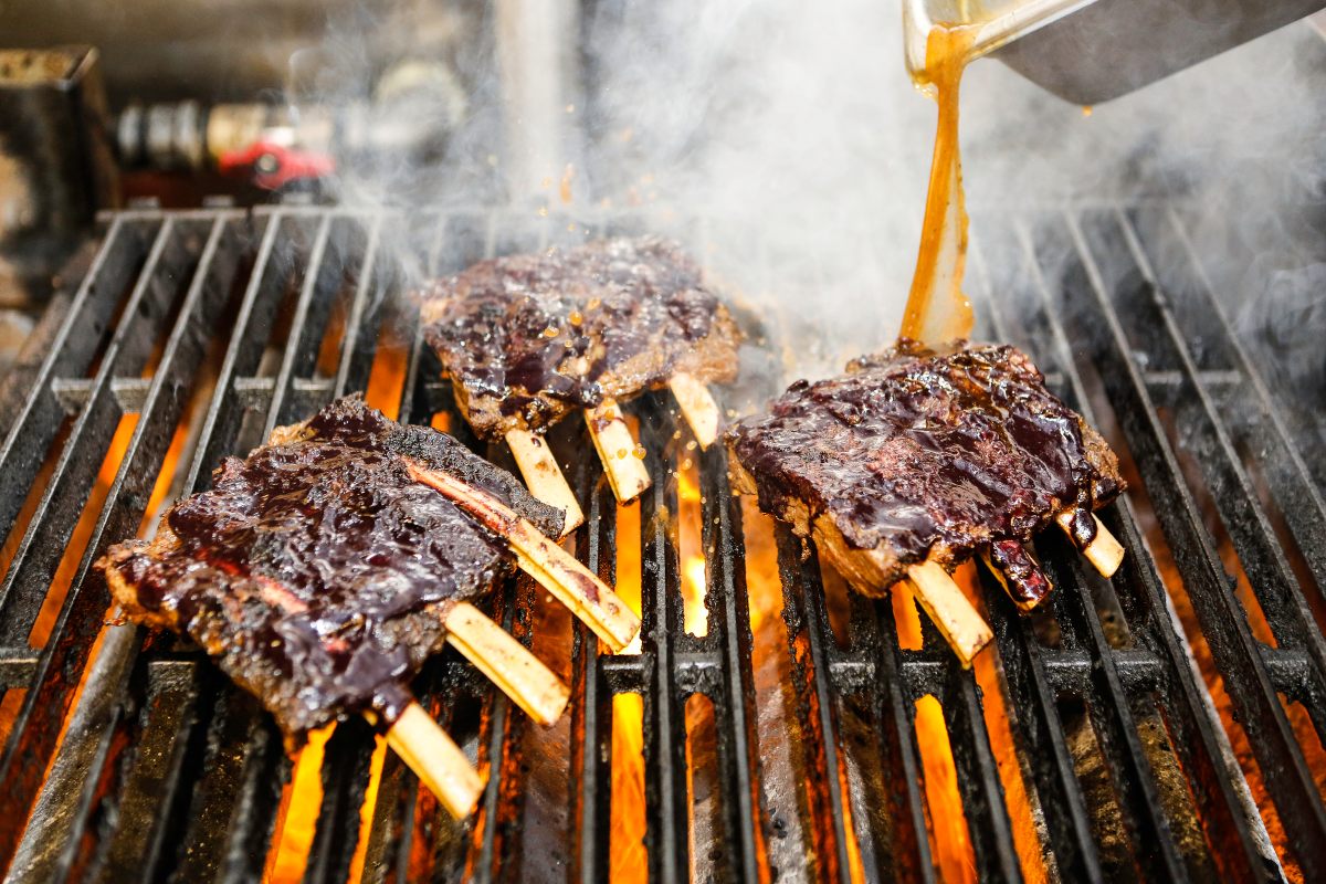 Bison ribs on the grill at Tocabe come with a berry glaze.