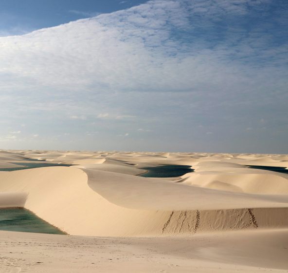 The rolling sand dunes of Lençóis Maranhenses in Brazil.