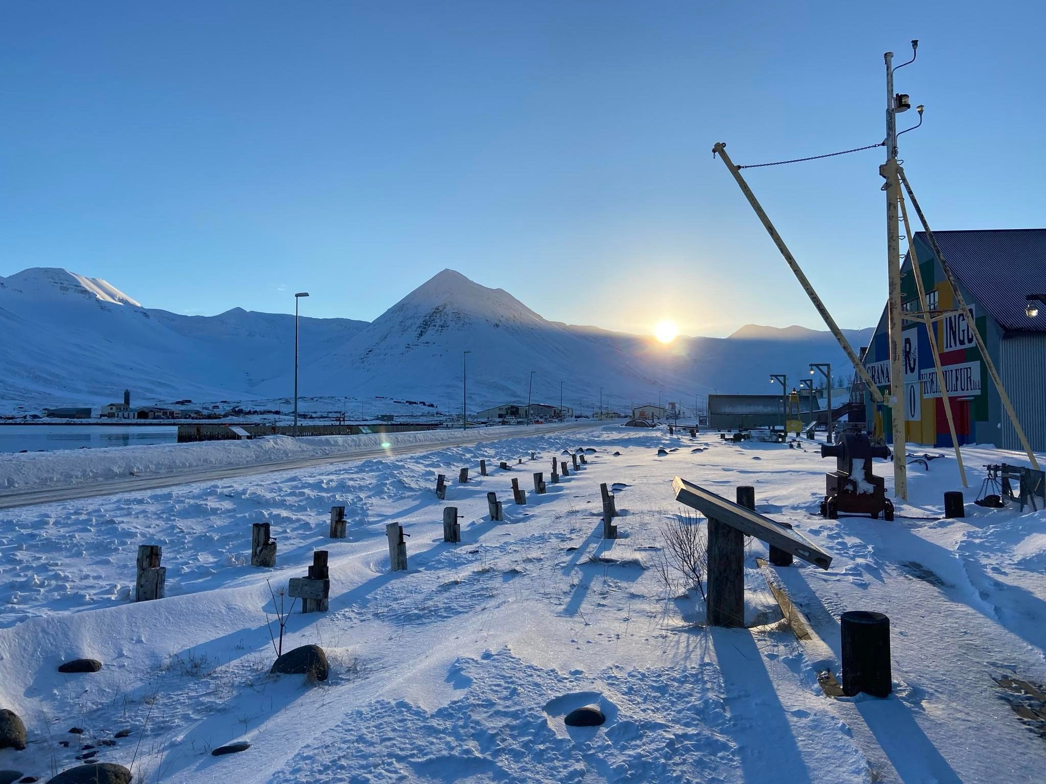 The sun finally peeking over the foothills into Siglufjörður.
