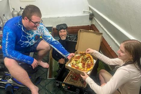 Fresh pizza delivered by a deep-sea diver. Delicious!