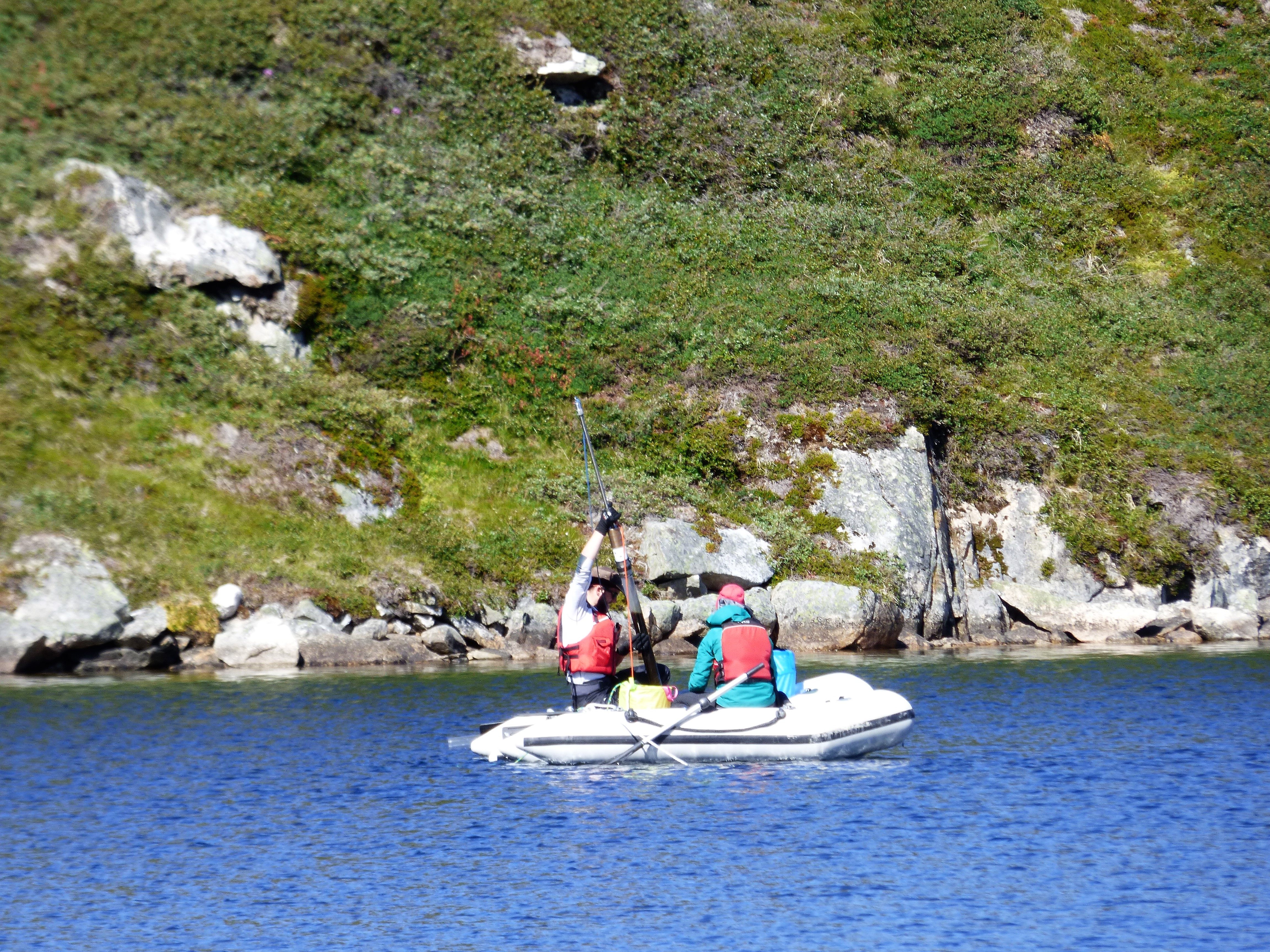 Scientists recover a sediment core from a southern Greenland lake in 2016.