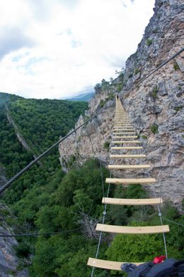 A suspended cable bridge over a gorge