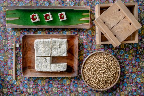 The tofu is cut into cubes and served with sweet soy paste and some wasabi on top.