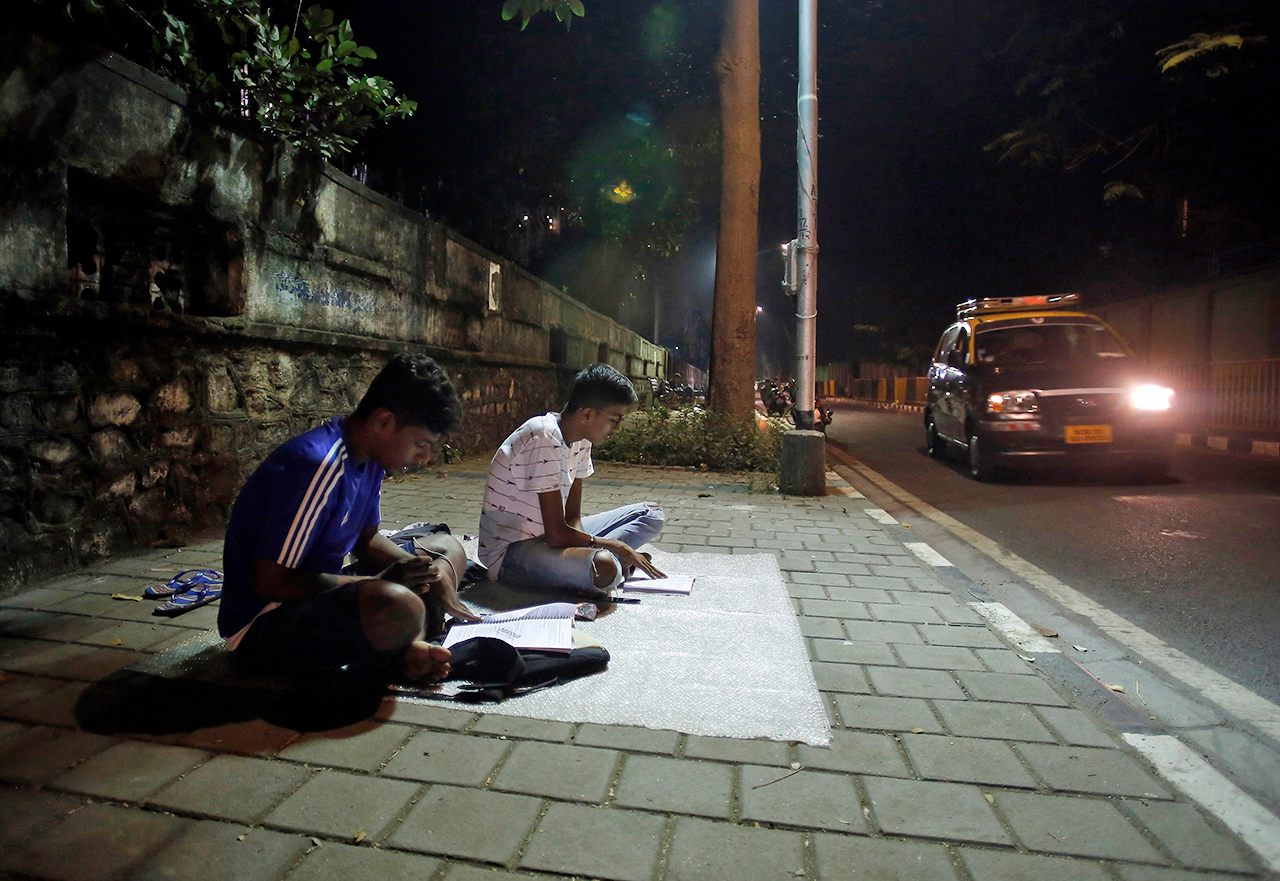 At "study corners" like Abhyas Galli, near the busy junction of Worli Naka in Mumbai, two students enjoy the peace and quiet they can't find at home. 