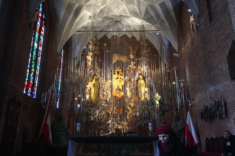 A church altar of sculpted amber saints that seems to float at the front of the church