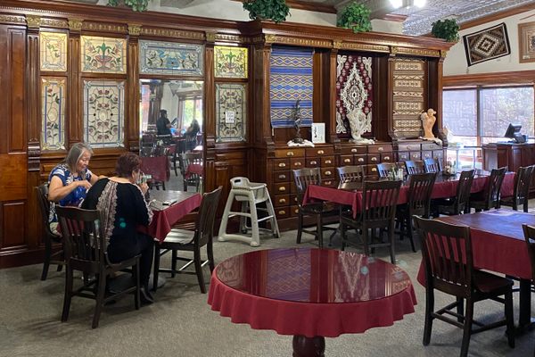 Antique furnishings, including a pressed tin ceiling, in dining room combine beautifully with Navajo and Hopi artwork.