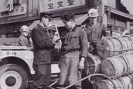 A policeman confiscates goods in 1949.