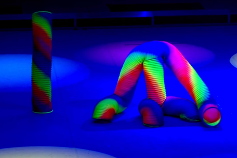 Watch These Human Slinkies Dance in a Neon Disco