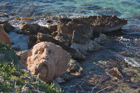 Sculpted Face on Shore