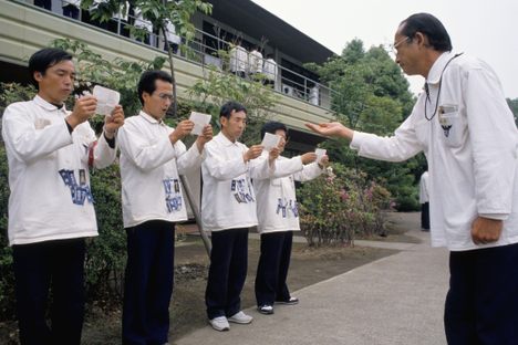 Hell camp executives in training in Japan, wearing "ribbons of shame."