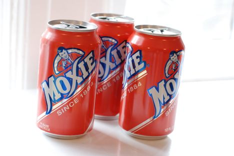 Cans of Moxie, likened to "root beer on steroids."