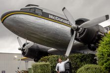 Author Gary He poses in front of a McDonald’s in Taupō, New Zealand, located in a retired DC-3 aircraft.