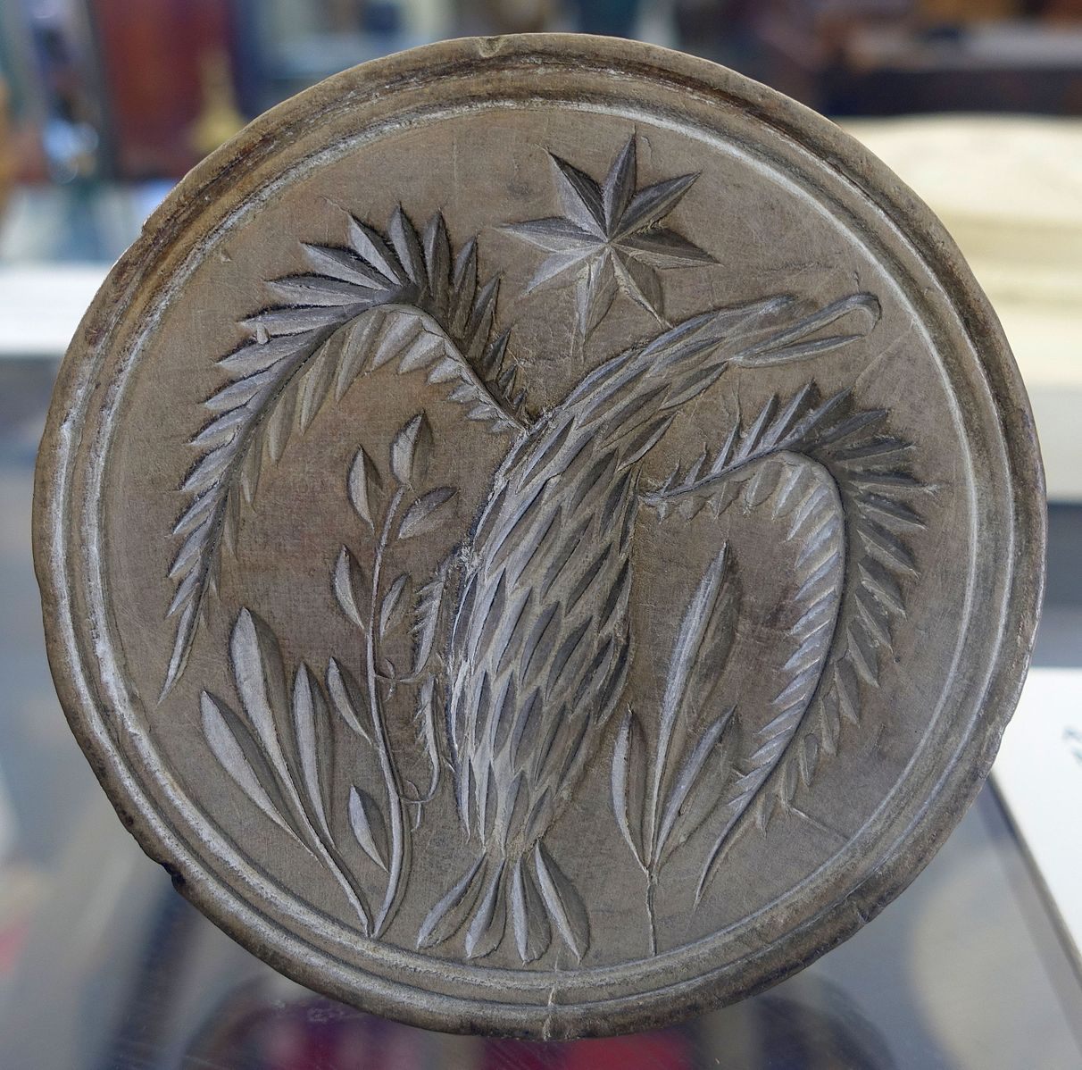 A carved wooden butter mold, from 1830.
