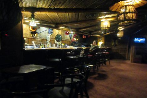 The dimly lit bar is an homage to tiki culture.