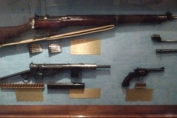 World War II Lee Enfield rifle and Sten sub-machine gun , bayonets, World War I Webley pistol.