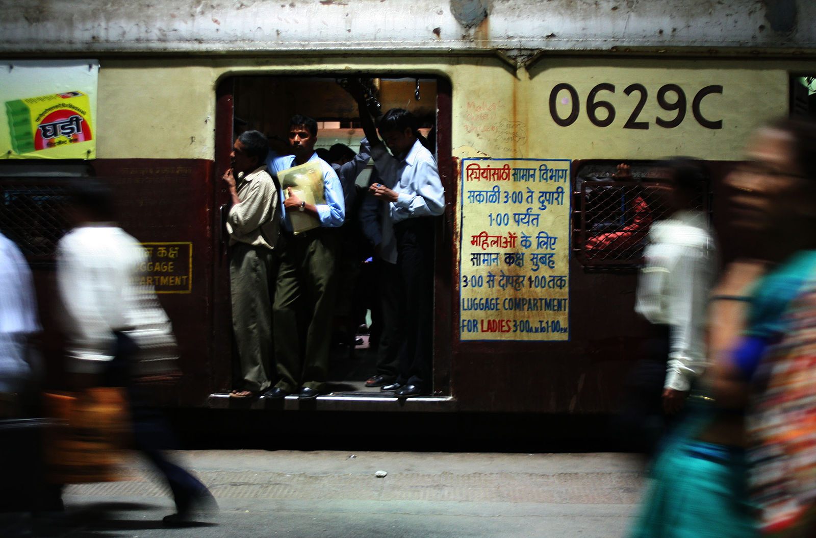 A typical weekday train in Mumbai. The sign on the right side indicates that this becomes a "Ladies Compartment" at certain times.