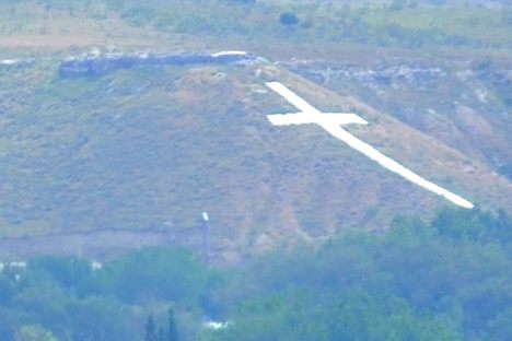 The huge white cross by the Madrid Airport is the Paracuellos Cementerio de los Martires.