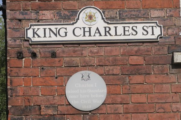 Street sign and plaque.
