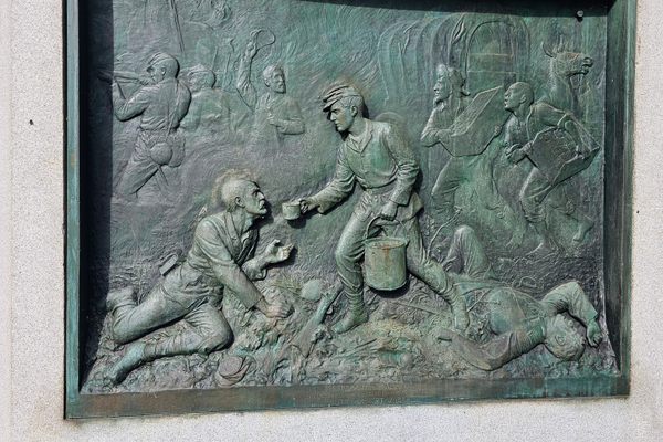 This unusual relief depicts a future president serving a cup of coffee to an injured soldier.