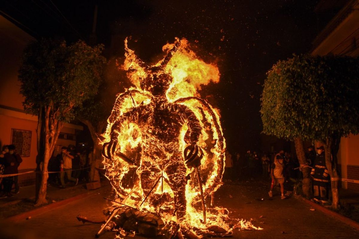 A figure representing the devil burns during the celebration of the Virgin of the Immaculate Conception in Guatemala City to mark the beginning of the Christmas season. (2021)