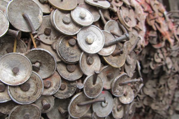 Coins nailed into the shrine.
