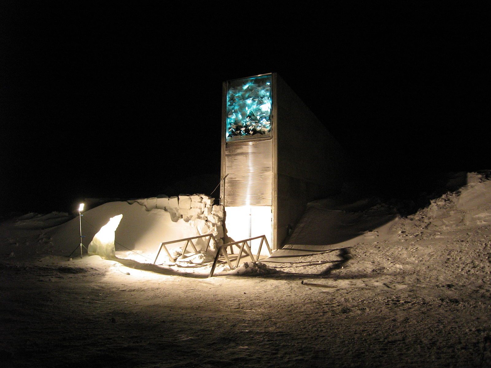 The Svalbard Global Seed Vault's main entrance, illuminated at night by a glowing art installation.