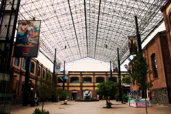 Legacy buildings of the paper factory surround the mall’s central court.