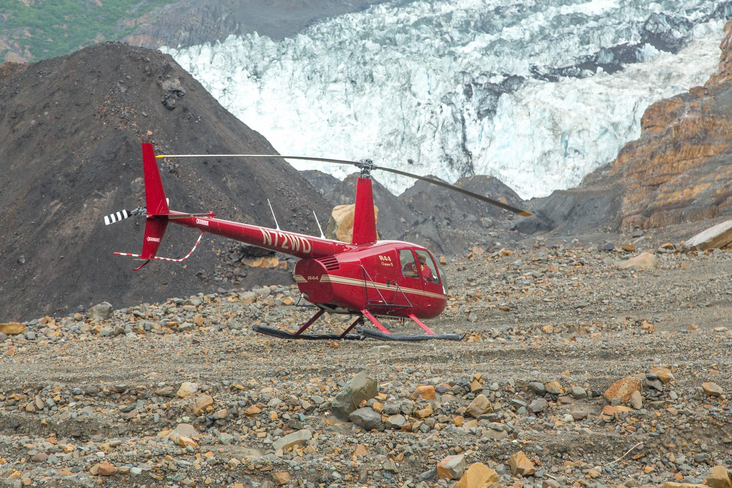 A Robinson 44 helicopter pauses on landslide debris, used to help scientists get an aerial perspective and extend their research reach.