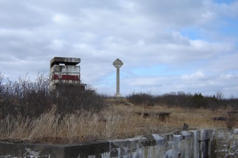 Remnants of a building and a Celtic cross commemorating Irish immigrants dead of typhus