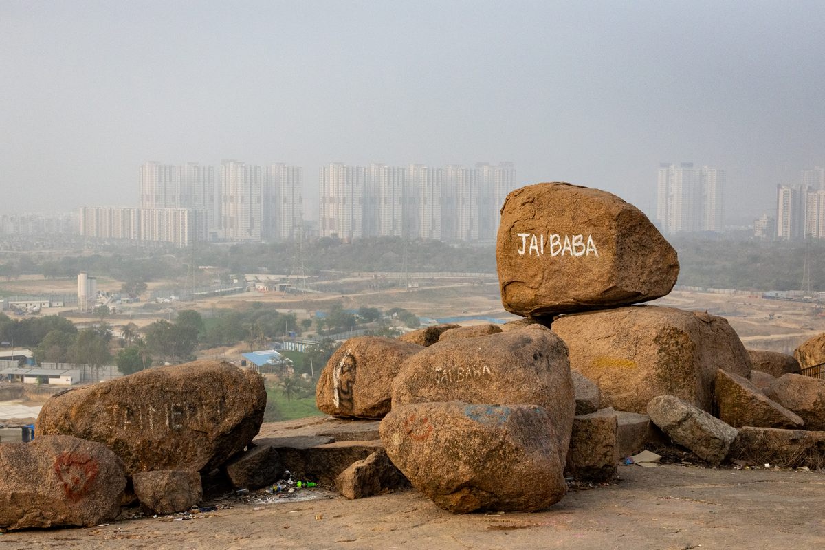Modern Hyderabad looms in the distance behind rocks that began forming 2.5 billion years ago.