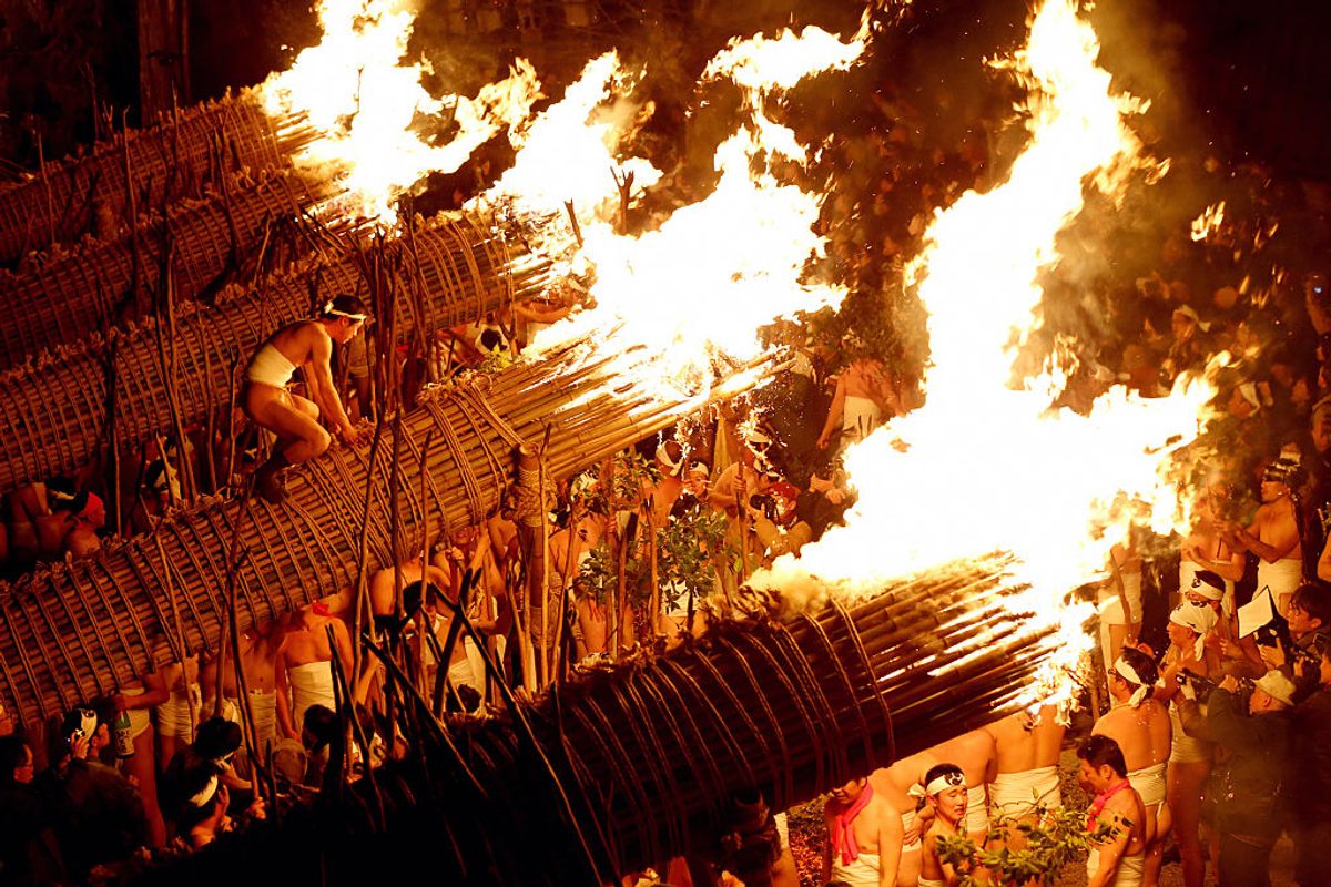 Men in traditional <em>shimekomi</em> loincloths light six giant torches during the Oniyo Fire Festival at Daizenji Tamataregu Shrine in Kurume, Japan. The festival, in prayer for good health, dates back more than 1,600 years. (2016)