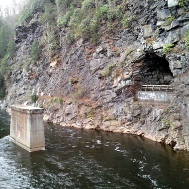 Abandoned bridge pylon and tunnel on old rail line parallel to the Lehigh Scenic Railway in the Lehigh Gorge