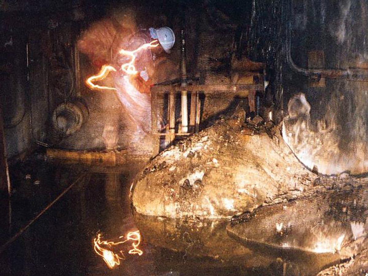 Artur Korneyev, Deputy Director of Shelter Object, viewing the “elephants foot” lava flow at Chernobyl, 1996.